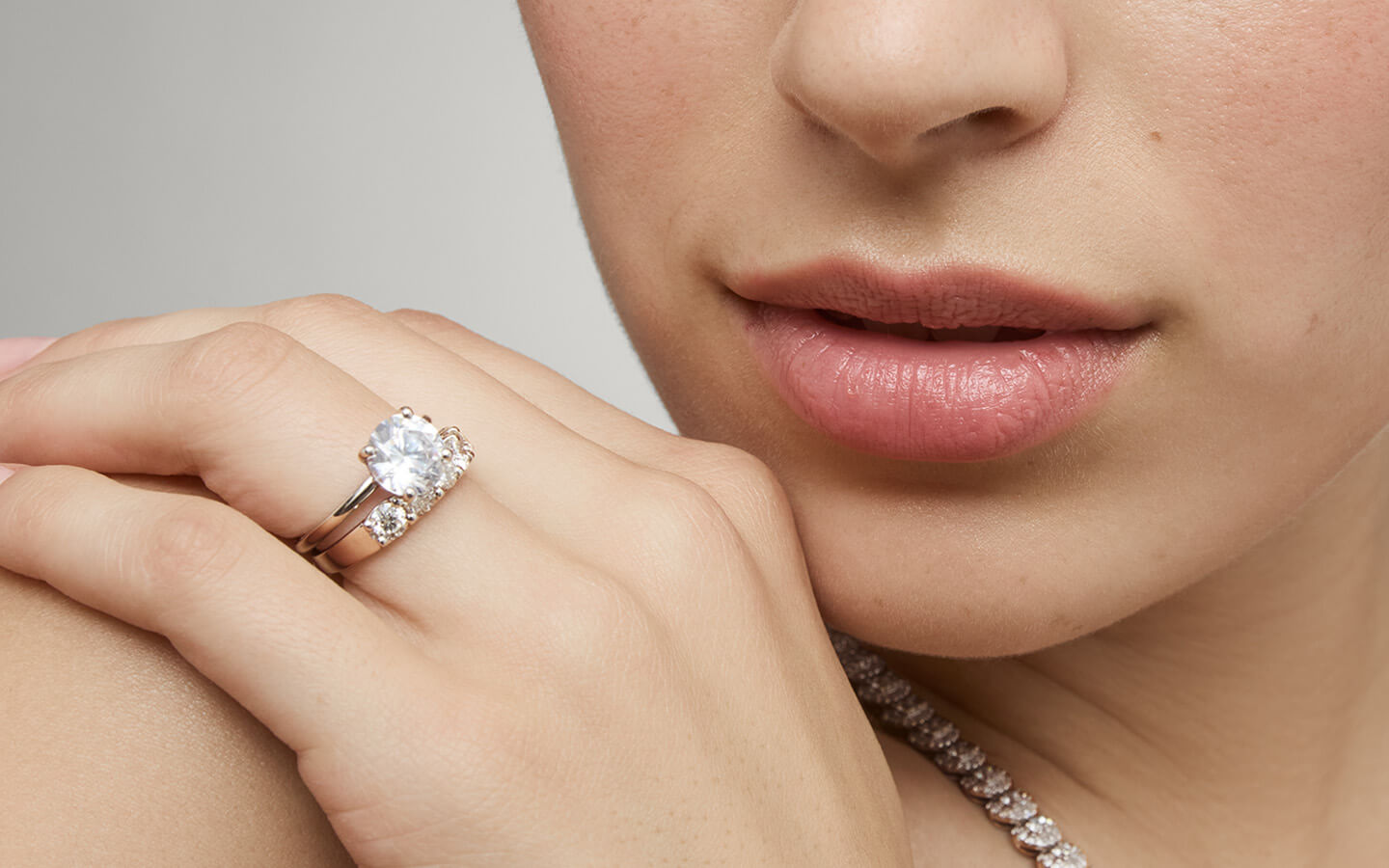 Close up of woman wearing diamond wedding ring set 