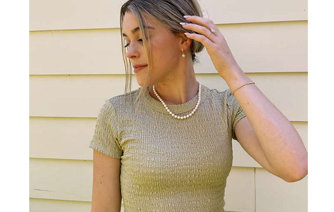 Young woman posing with pearl necklace