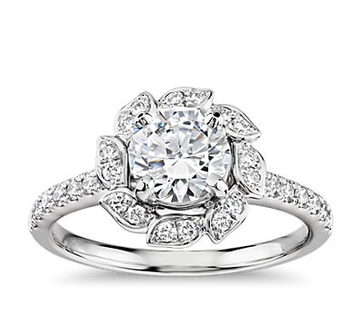 White gold diamond engagement ring with leaf-shaped accents