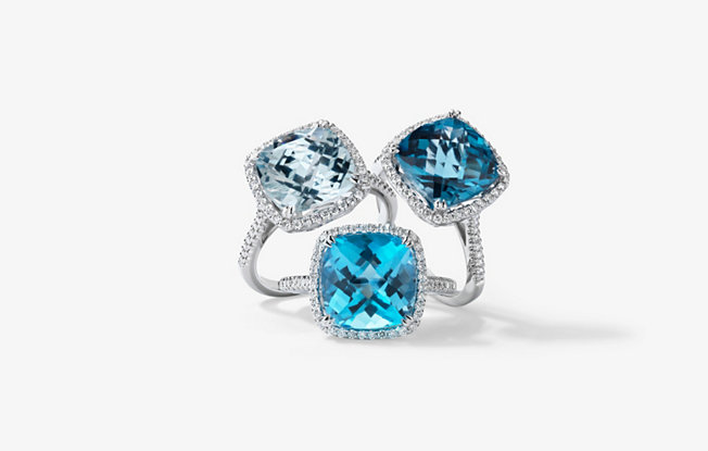 3 square cut topaz engagement rings in varying shades of blue