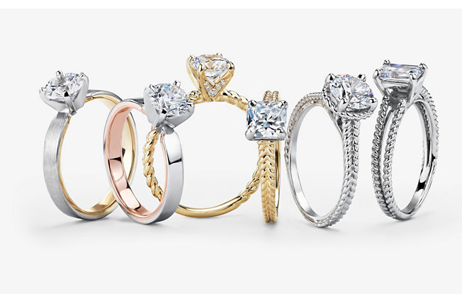 6 diamond engagement rings in various styles on a white background