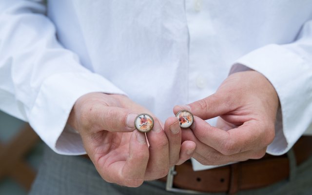 Man showing custom cufflinks