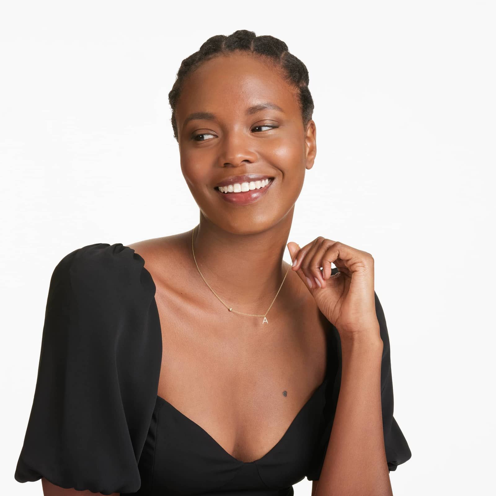 Woman wearing initial pendant in yellow gold