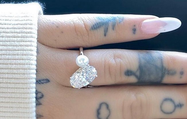 A close up of Ariana Grande's two stone engagement ring