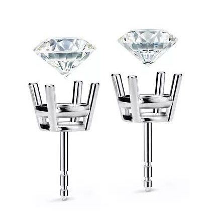 White gold four prong earrings being set with round diamonds.