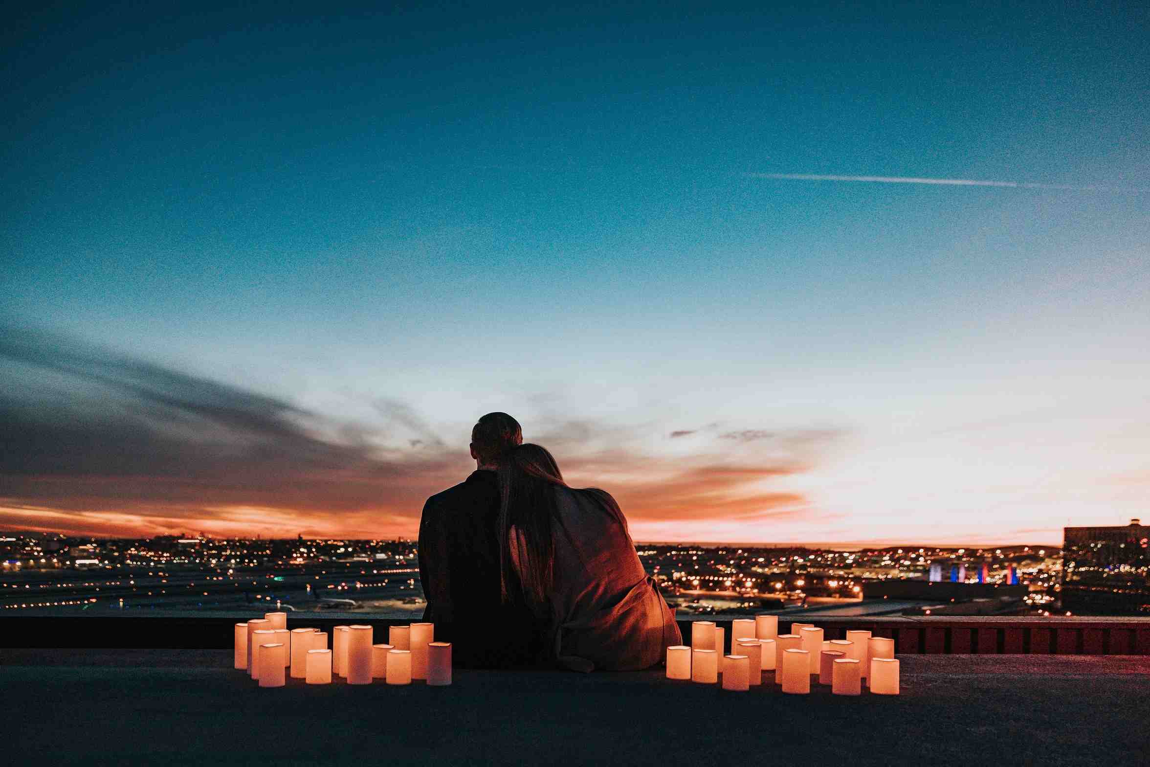 Couple sitting together overlooking the city after their commitment ceremony.