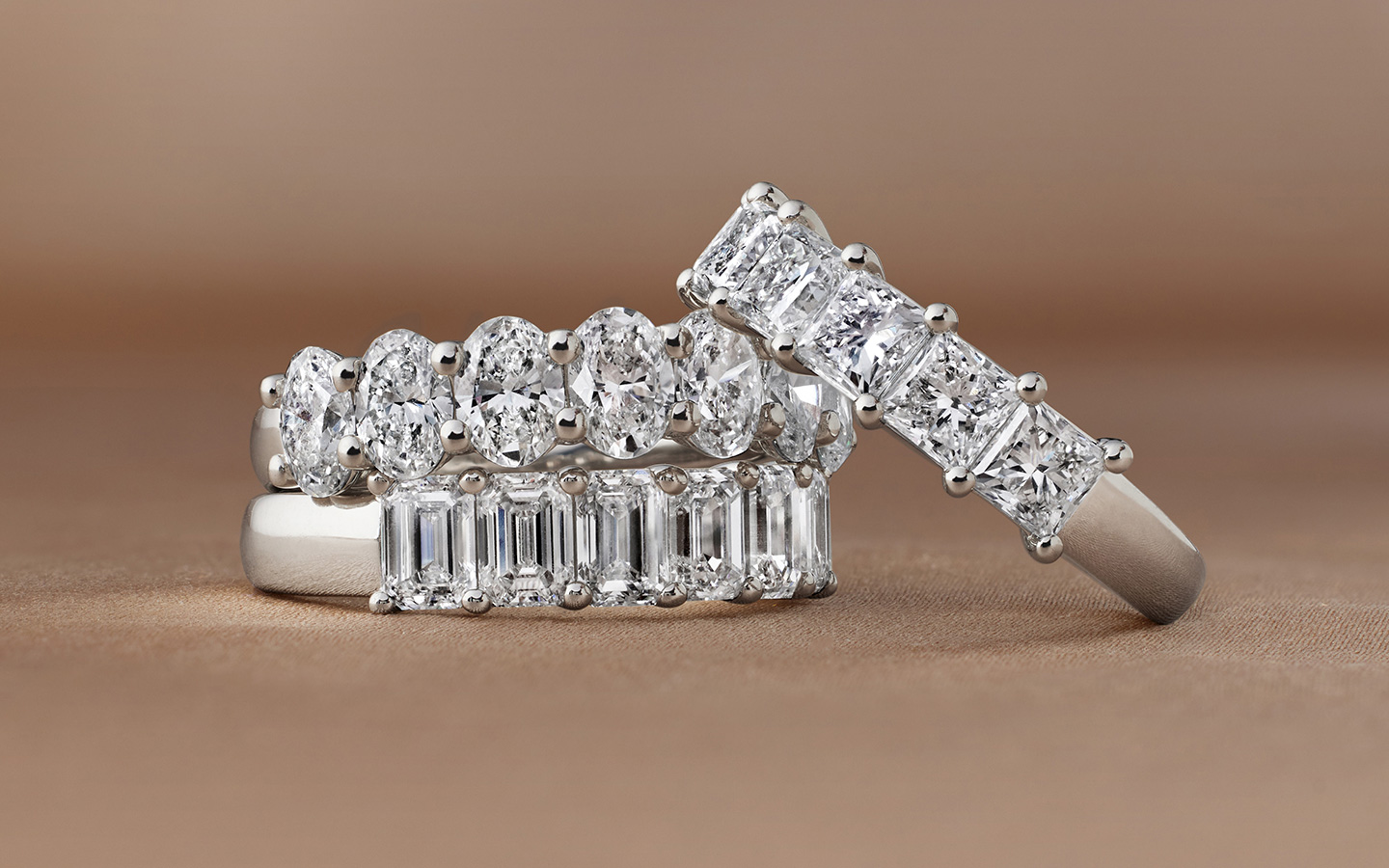 Three wedding bands with diamonds in white gold and platinum.