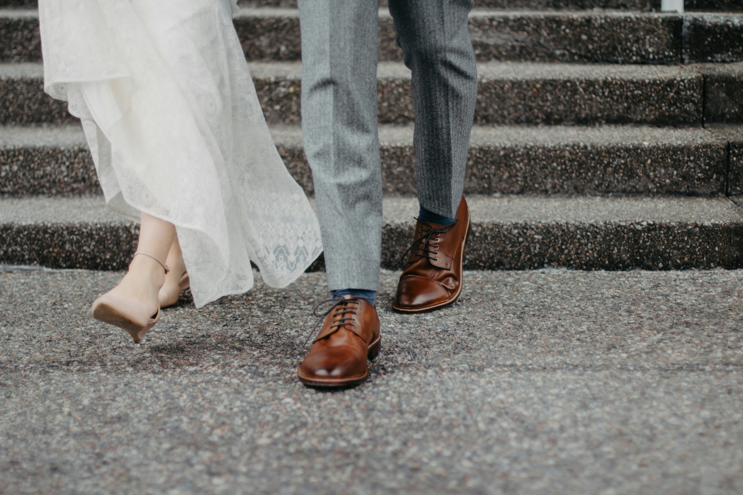 Photo of a bride and groom’s feet at the courthouse as they exit their ceremony.