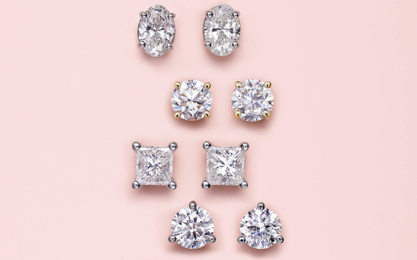 Four brilliant cut diamond stud earrings including oval, round and princess diamonds. 