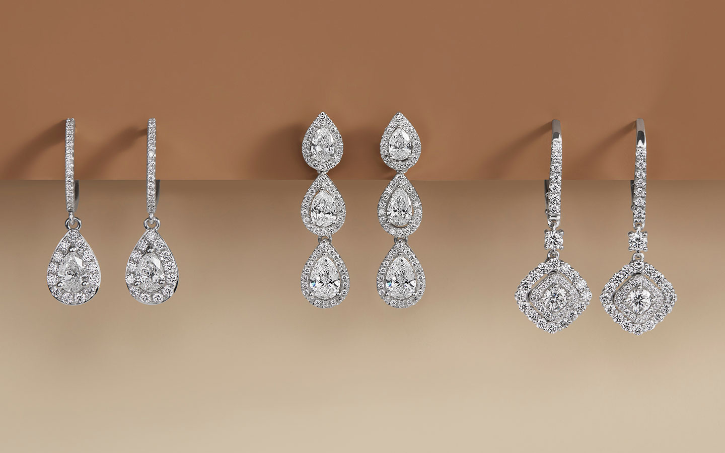 Three pairs of diamond and white gold dangling earrings.  