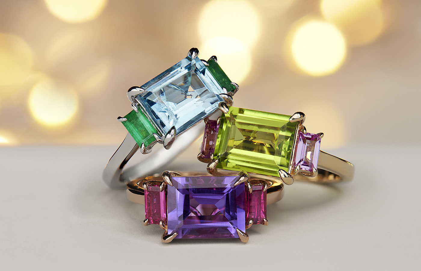 Gemstone rings with east west set main gems.