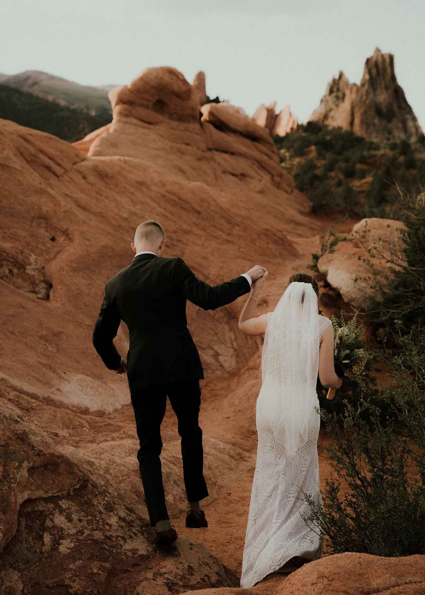 Bride and groom walking back from their desert elopement ceremony.