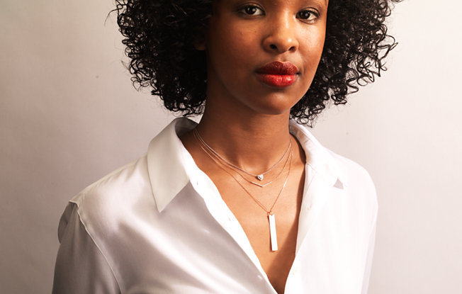 A woman wearing three necklaces