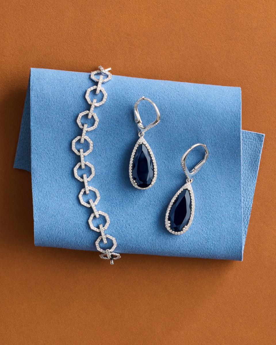 A white metal Sapphire Earring set with a chain bracelet