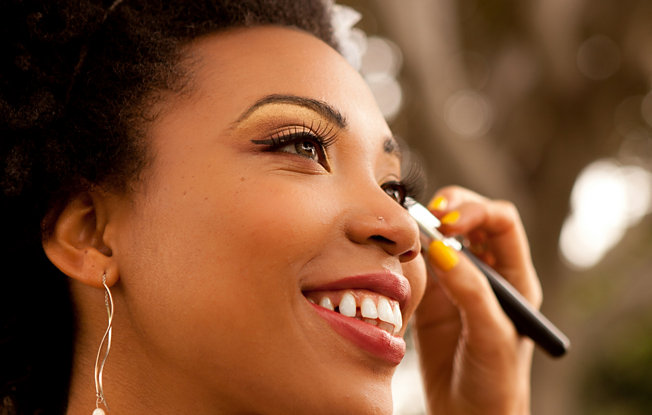 A woman getting her makeup done by a professional makeup artist for her wedding
