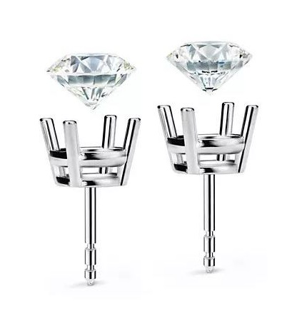 Deconstructed diamond stud earrings with the diamonds floating above the settings 