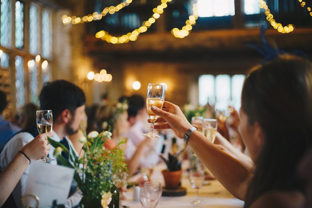Wedding guests toasting during a reception.