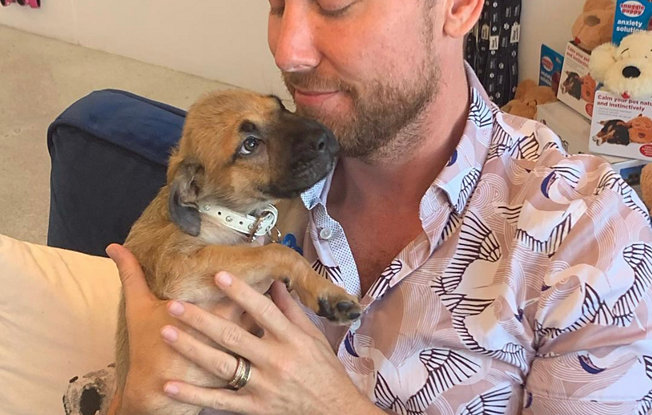Lance Bass holding a puppy