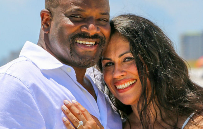 Mayra displays her diamond engagement ring while giving William a hug