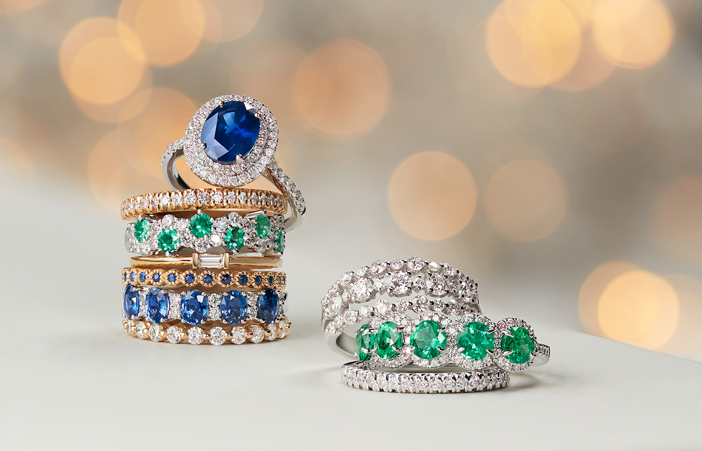 Stack of gemstone and diamond rings, including promise rings.