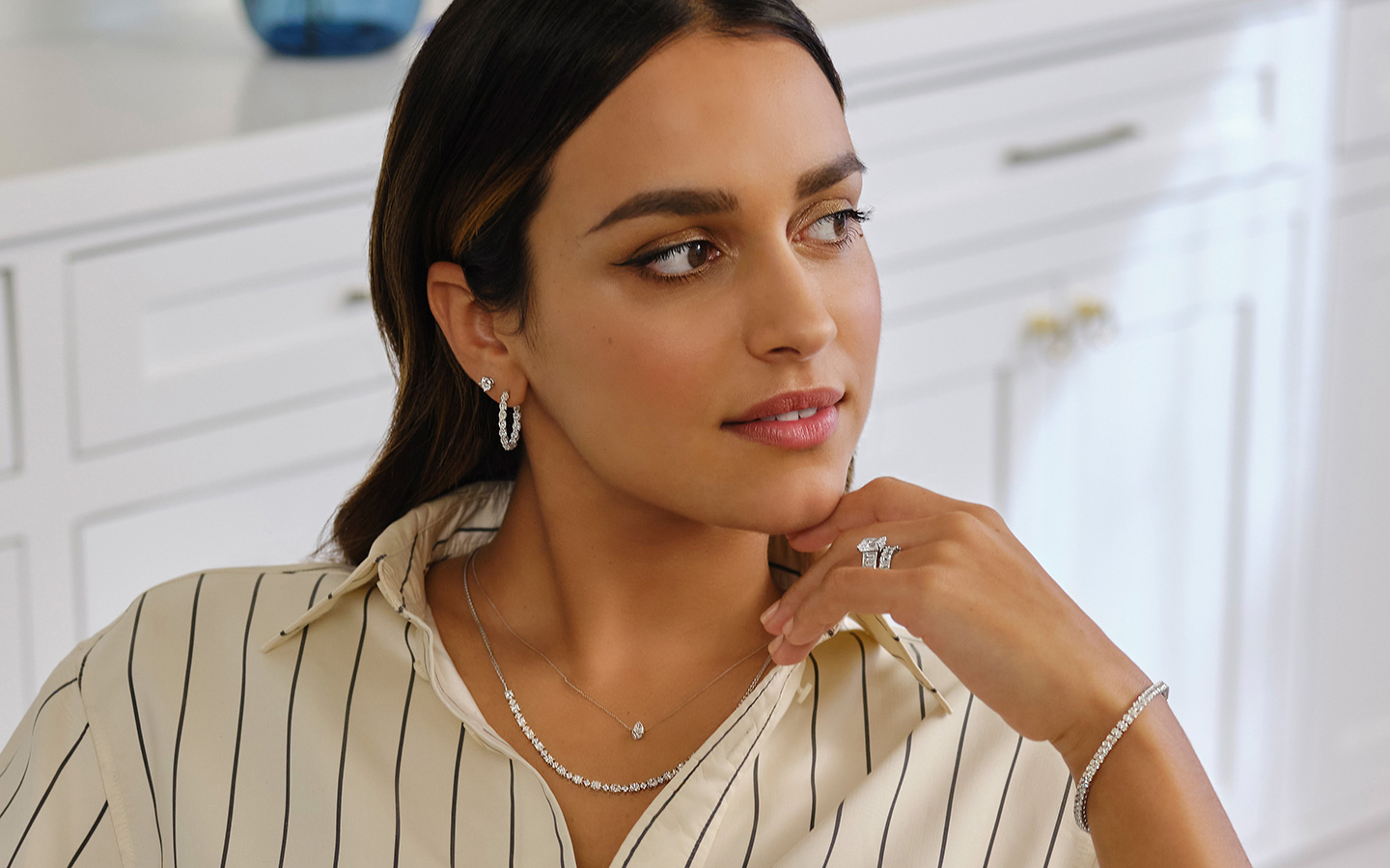 Photo of a woman wearing quiet luxury fashion including diamond jewelry.