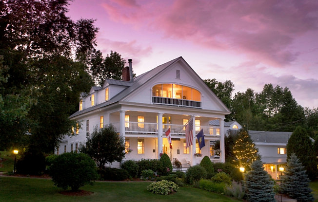 A large white house at sunset