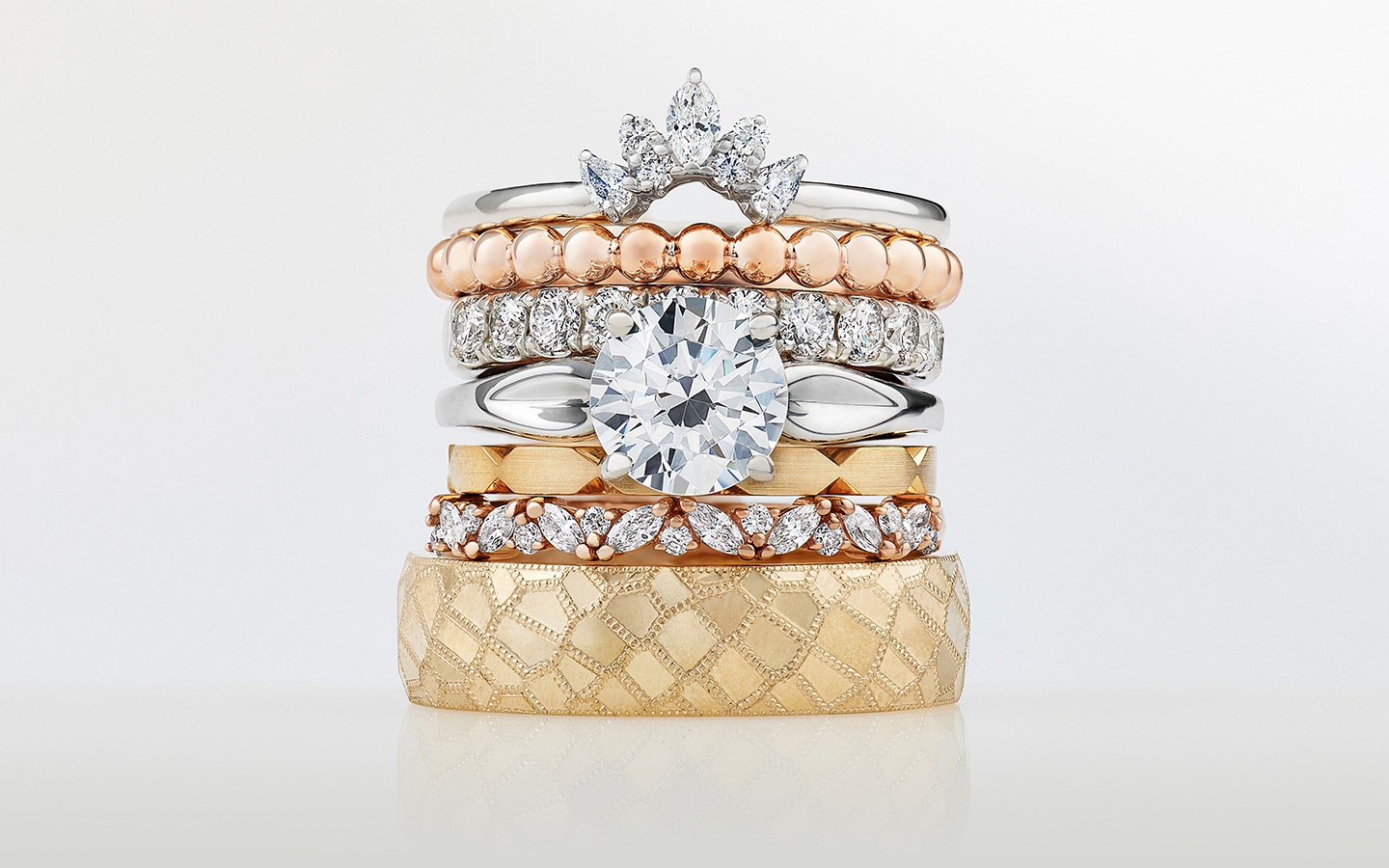 Wedding and engagement ring stack, including two plain metal spacer rings.