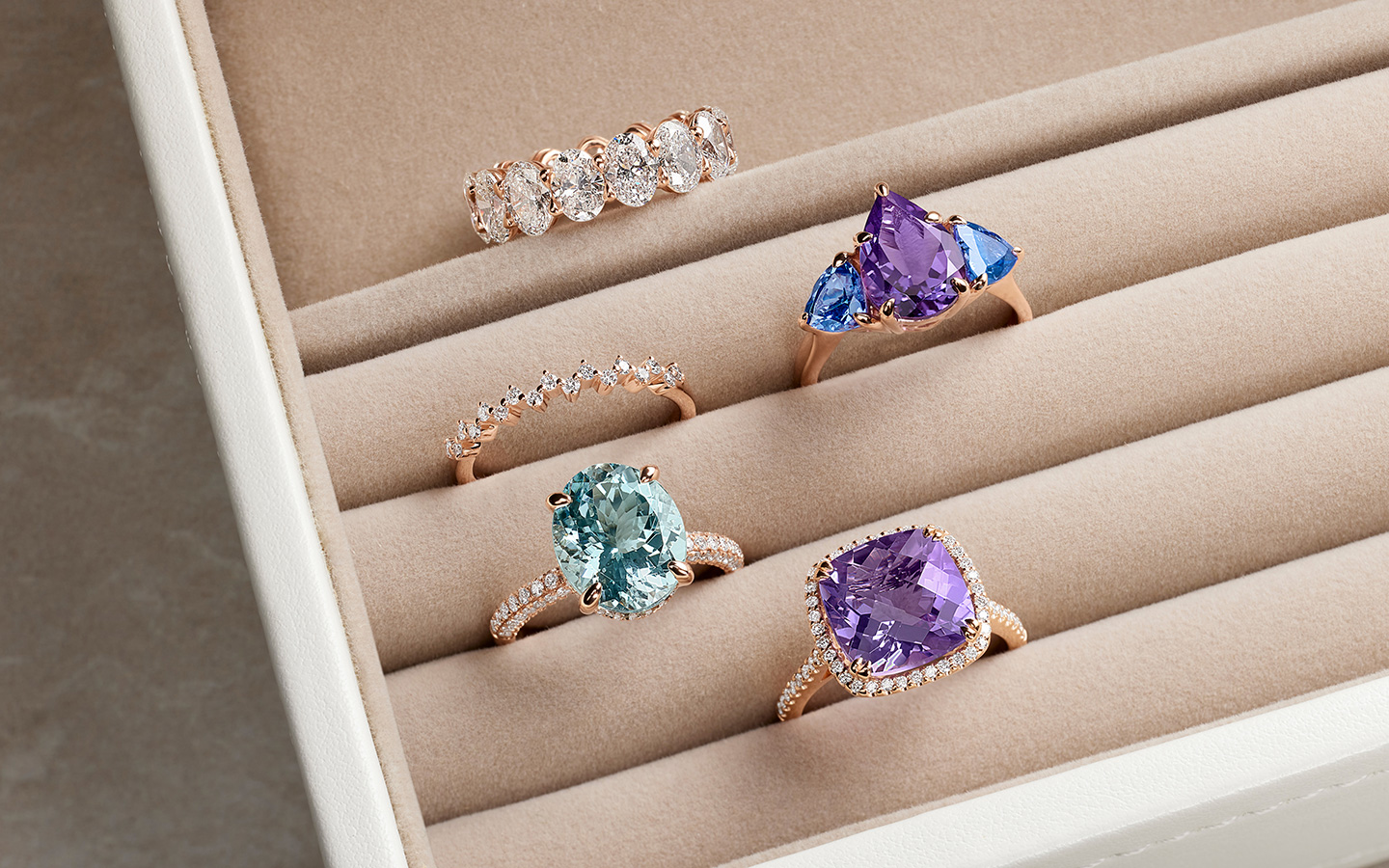 Rose gold rings in a light colored jewelry box.