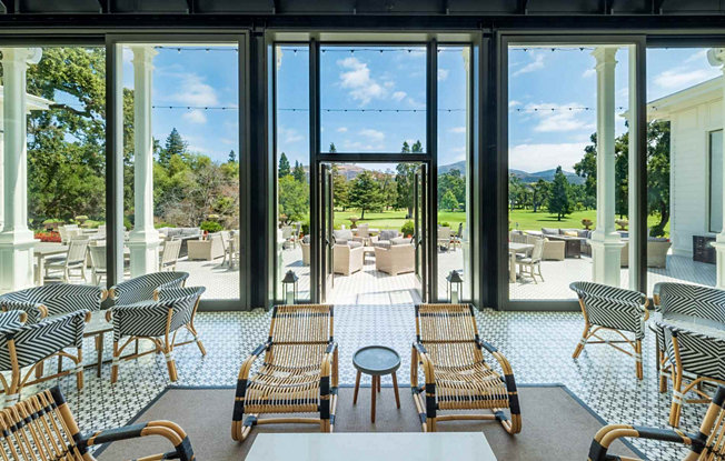 A hotel lounge room set on a forest landscape