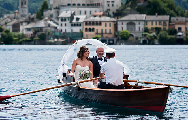 A couple celebrating their wedding on a gondola in Italy