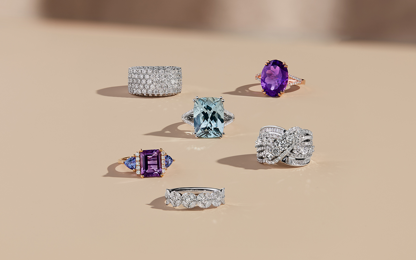 Six unique gemstone and diamond engagement rings including amethyst and blue topaz rings.