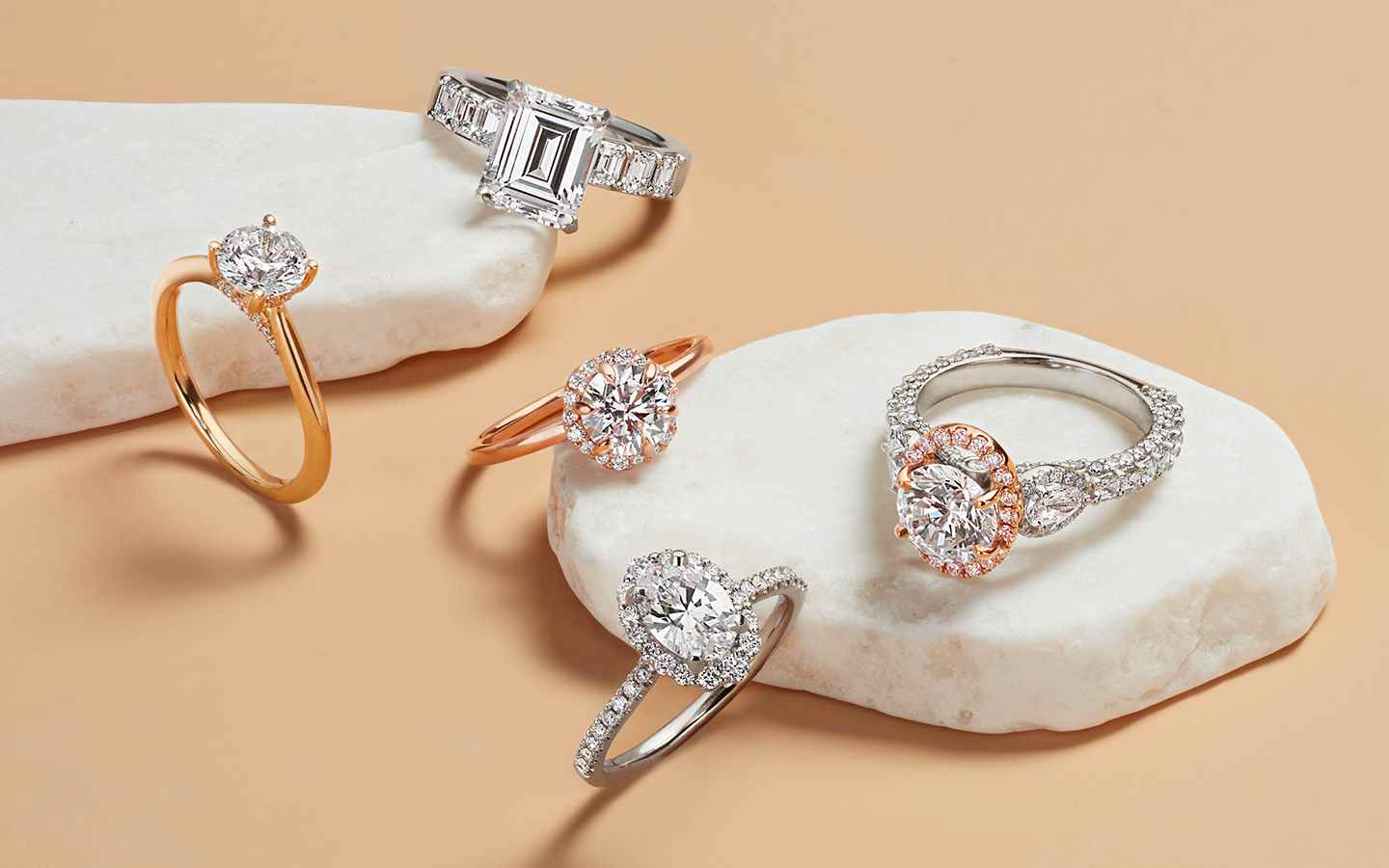 Five engagement rings including white gold, rose gold and platinum rings with diamonds.