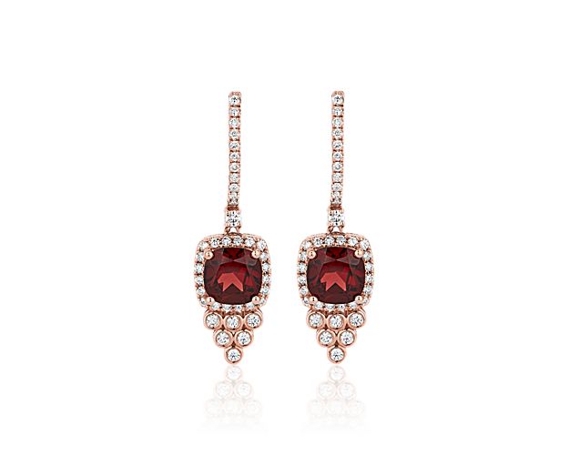 Gold and garnet drop earrings with diamond accents. 