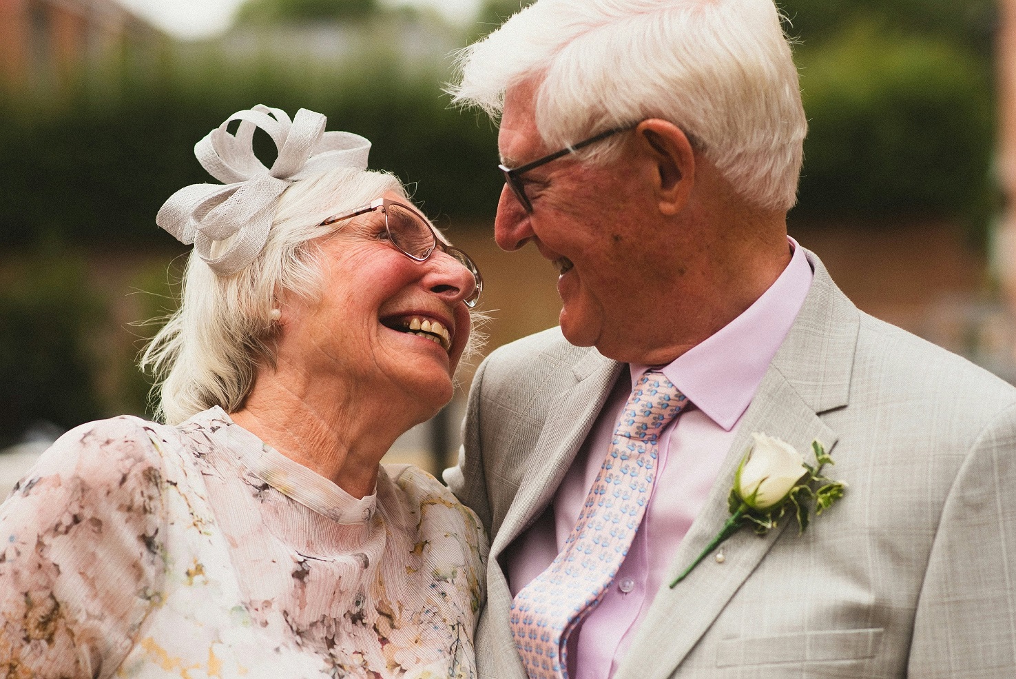 Husband and wife smiling at each other before their vow renewal ceremony. 
