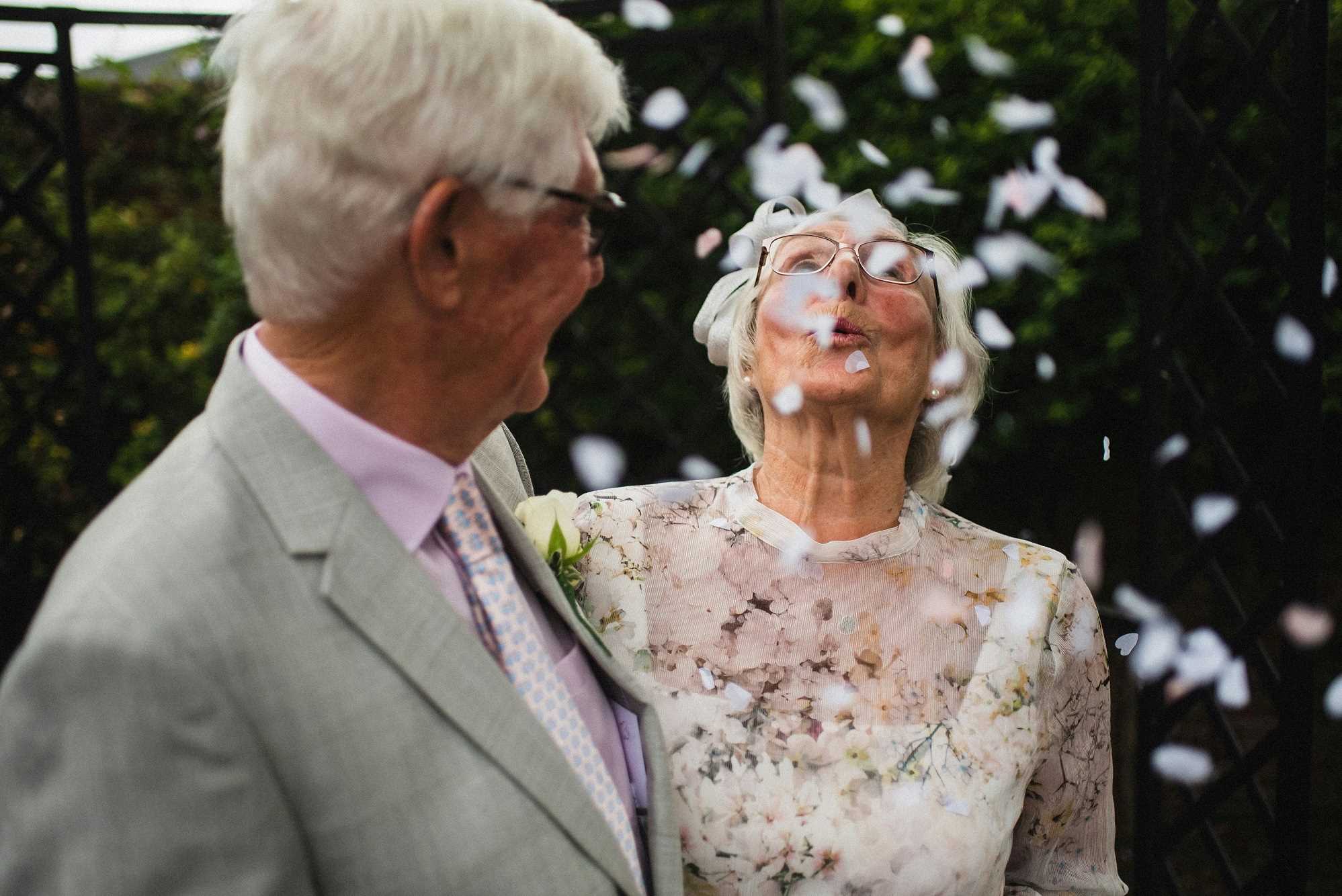 Married couple celebrating with confetti on their vow renewal day.