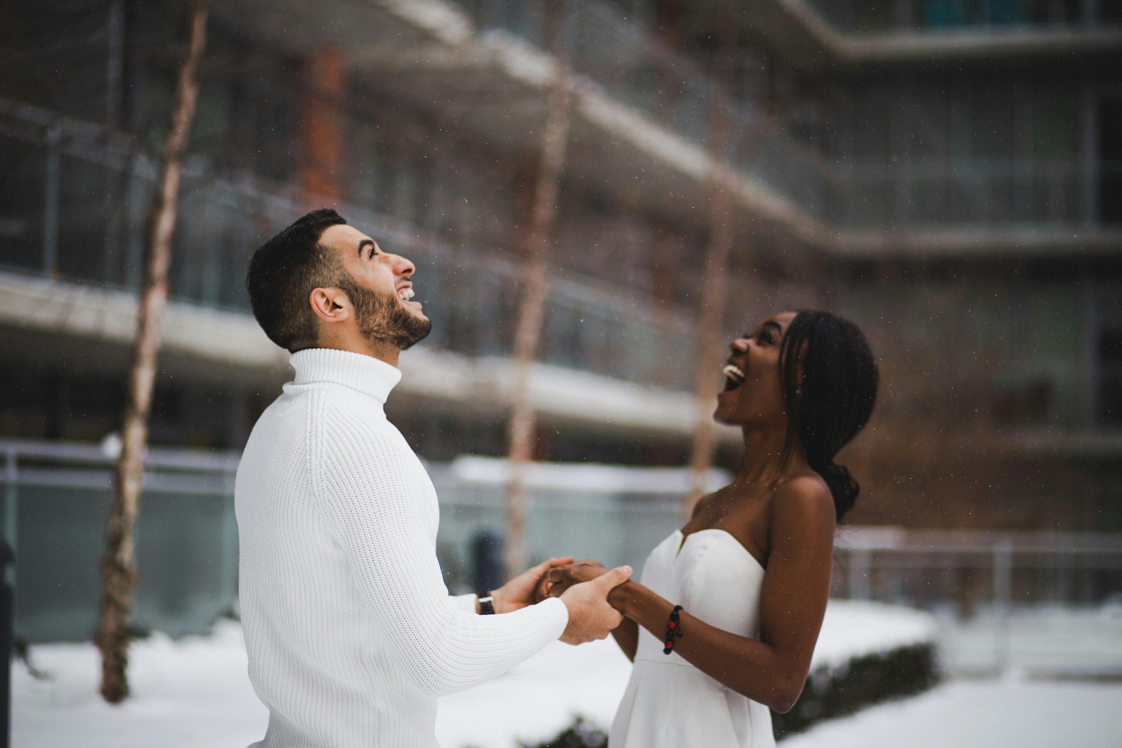Couple smiling in the snow at their wedding vow renewals. 