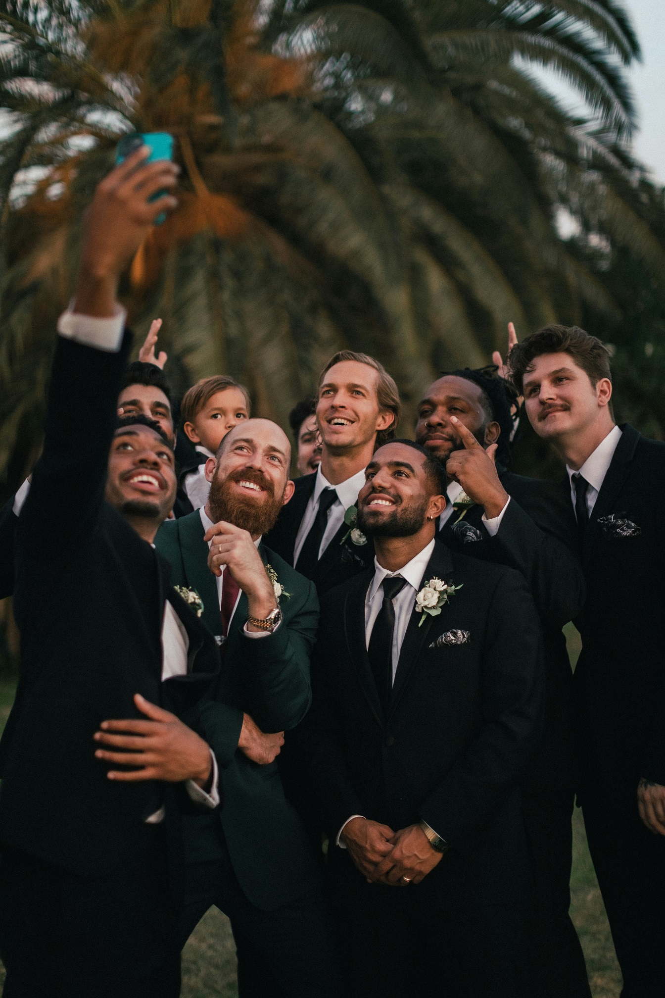 Groomsmen taking a selfie on a wedding day.
