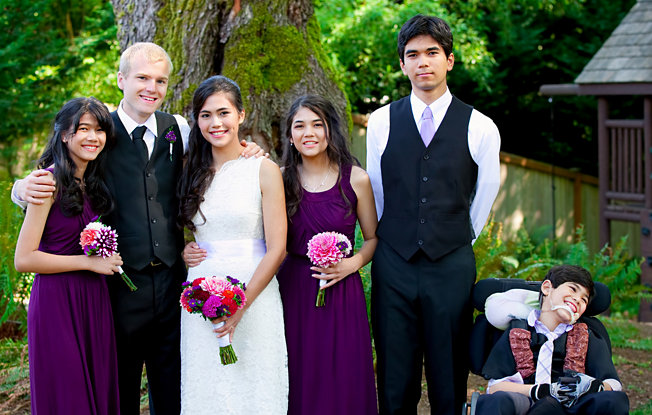 A bride, groom and family at a wedding