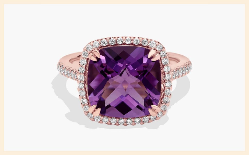 Cushion-cut purple amethyst in a rose gold halo setting with small white stones, a bold choice for unique stones for engagement rings
