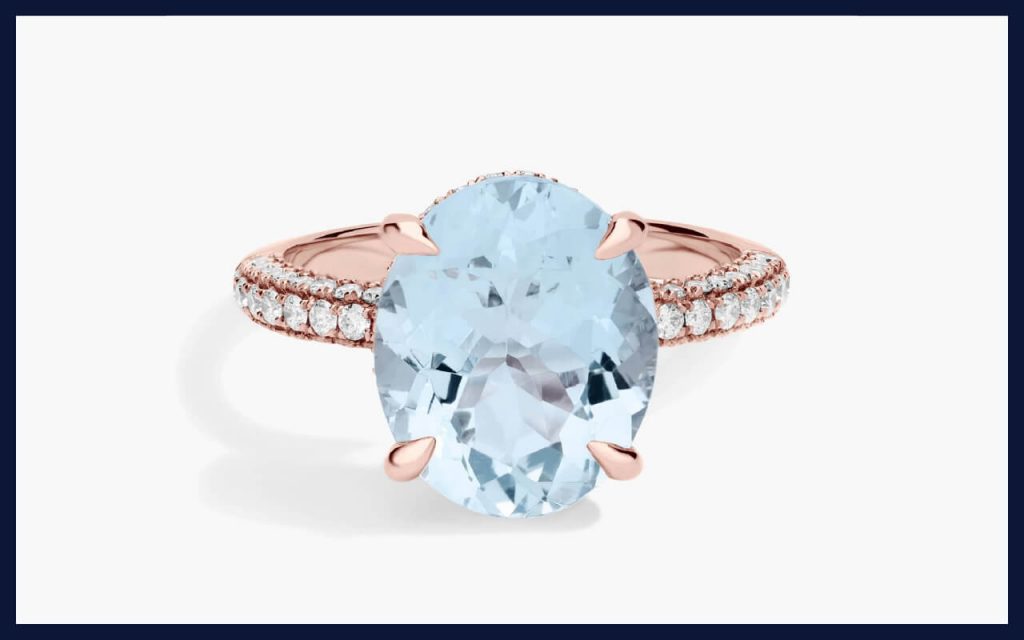 Oval aquamarine set in rose gold with a sparkling pavé band, giving a soft pastel look among the best alternative stones for engagement rings