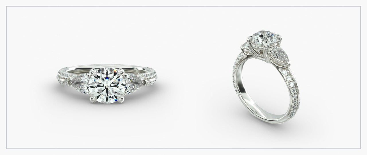 Front and side views of a white gold diamond basket head ring