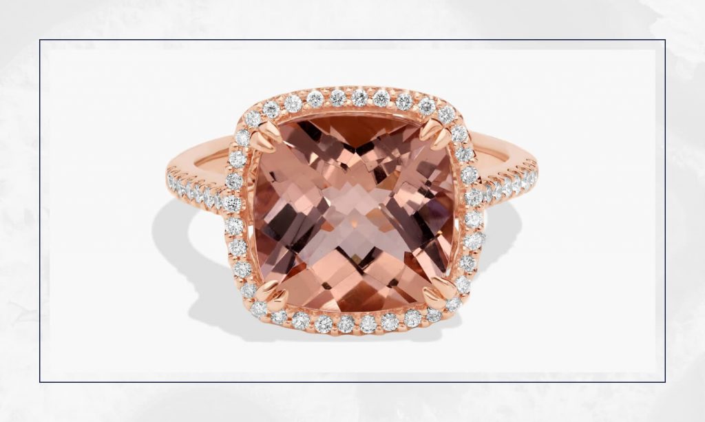 Rose gold ring with a cushion-cut morganite framed by a diamond halo, highlighting colorful stones in current engagement ring trends