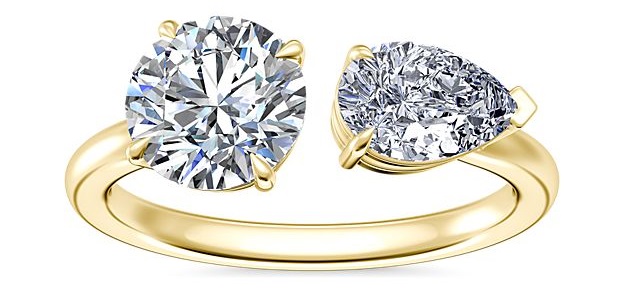 Two stone engagement ring in yellow gold with an east west pear diamond.