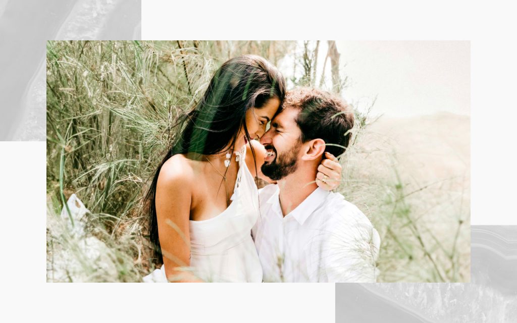 An engaged couple, forehead-to-forehead. 