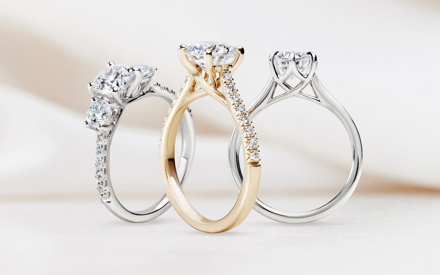 Three engagement rings including a cathedral engagement ring 