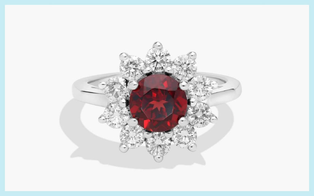 Round red garnet surrounded by bright white stones, an eye-catching style for alternative engagement stones