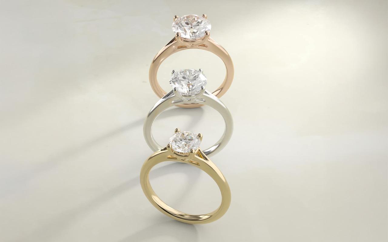 Petite split shank solitaire in 14k yellow gold featuring a pear-shaped I colored diamond center