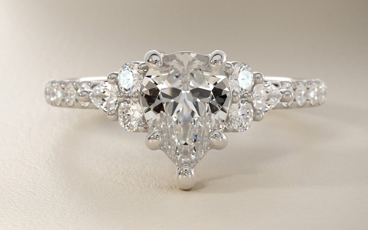 Romantic round and pear cluster diamond engagement ring in 14k white gold with an I colored diamond center