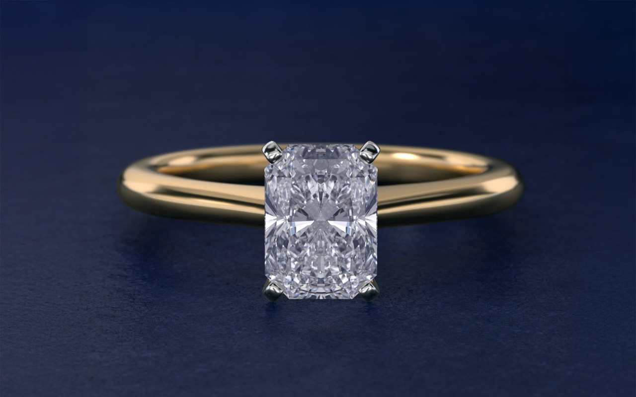 Petite solitaire engagement ring in 14k yellow gold set with a pear-shaped I colored diamond center