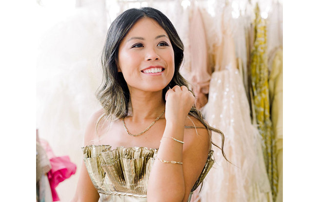 Smiling woman in a party dress wearing chain necklace and two bracelets - Top Influencer Jewelry Selections